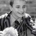 black and white photo of boy smiling