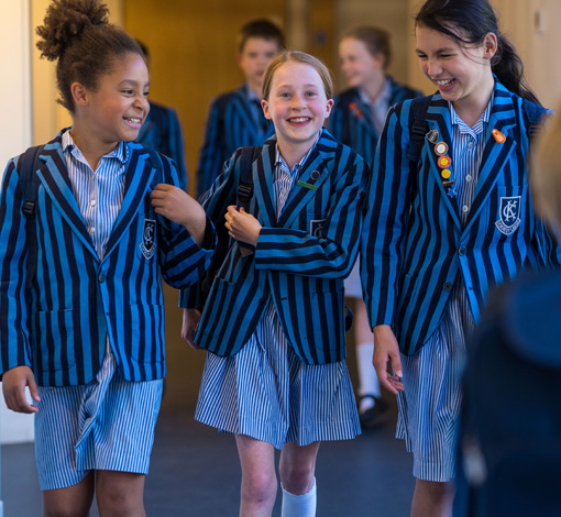 3 girls walking in their uniform