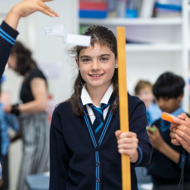 student holding a metre stick