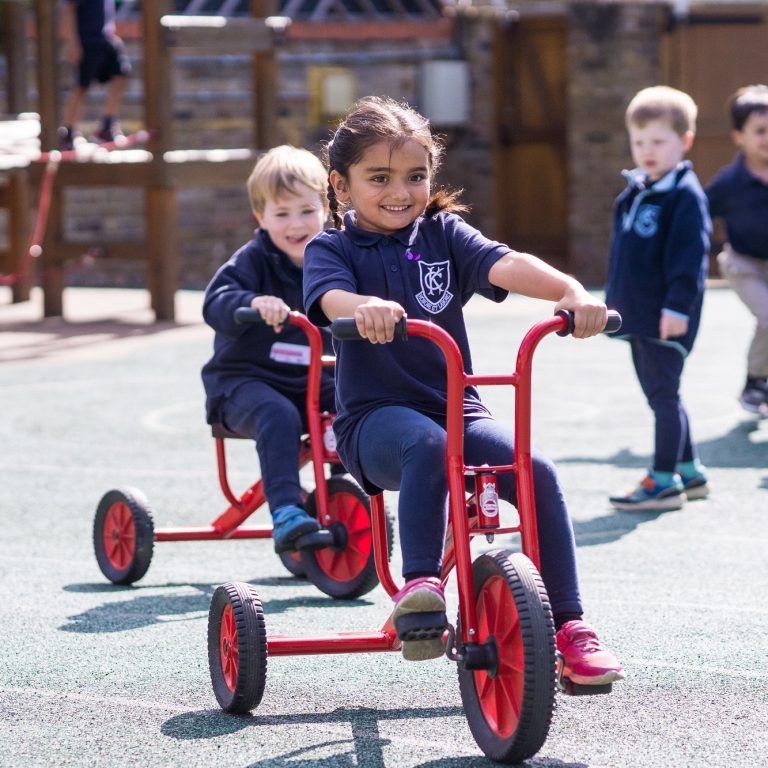 Students playing with their tricycles