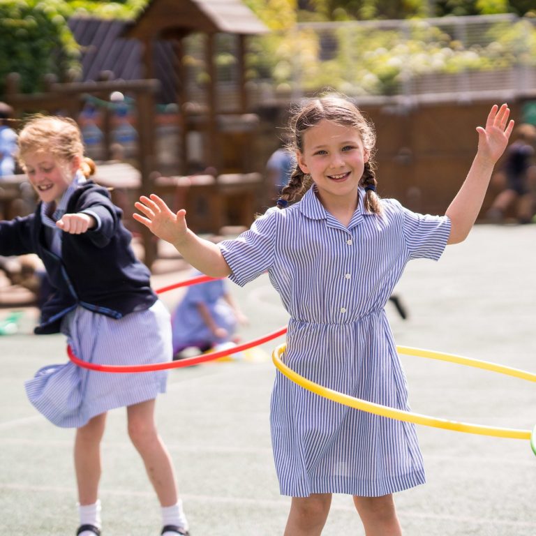 Students playing with their hula hoops in the playground