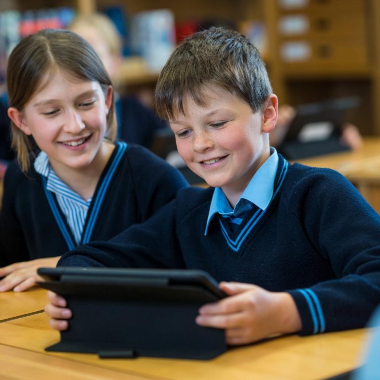 Students working on an iPad in the library