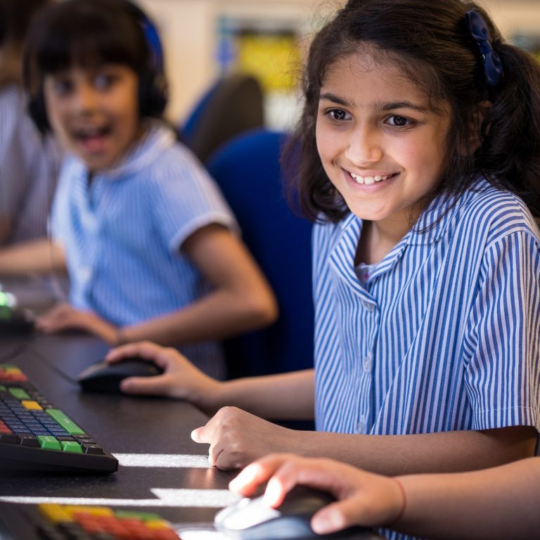 Students working on their computers to complete work