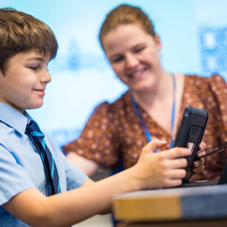 Student and teacher looking at an iPad together