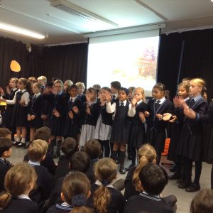 Pupils standing in front of their peers