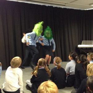 students wearing grinch masks