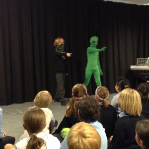 student dressed as an alien and masked boy