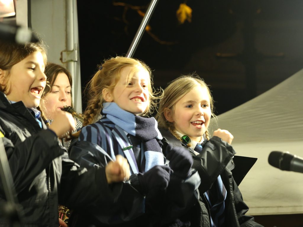 children stood outside singing