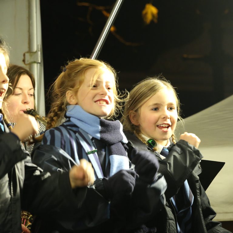 children stood outside singing