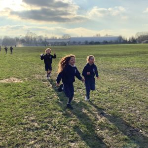 children running on a school field