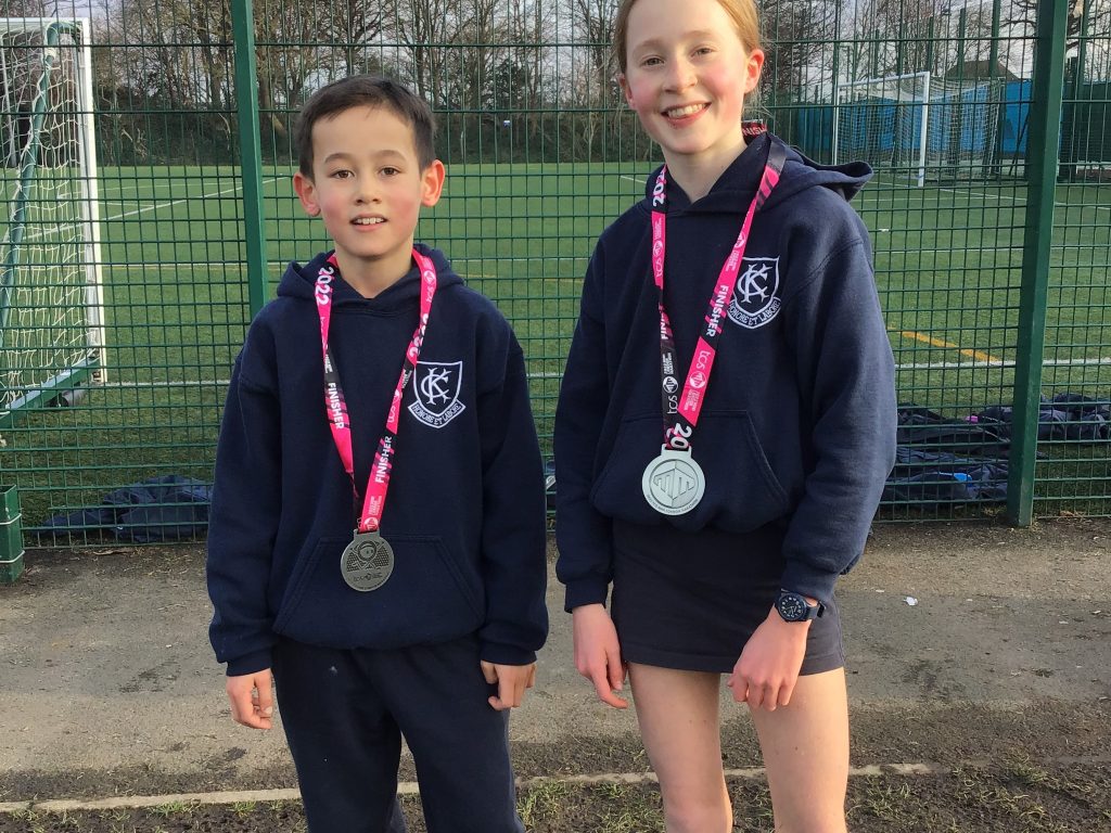 boy and girl wearing a medal