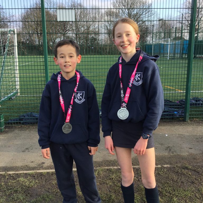 boy and girl wearing a medal