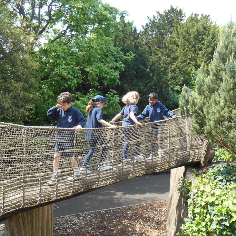 students walking across a bridge