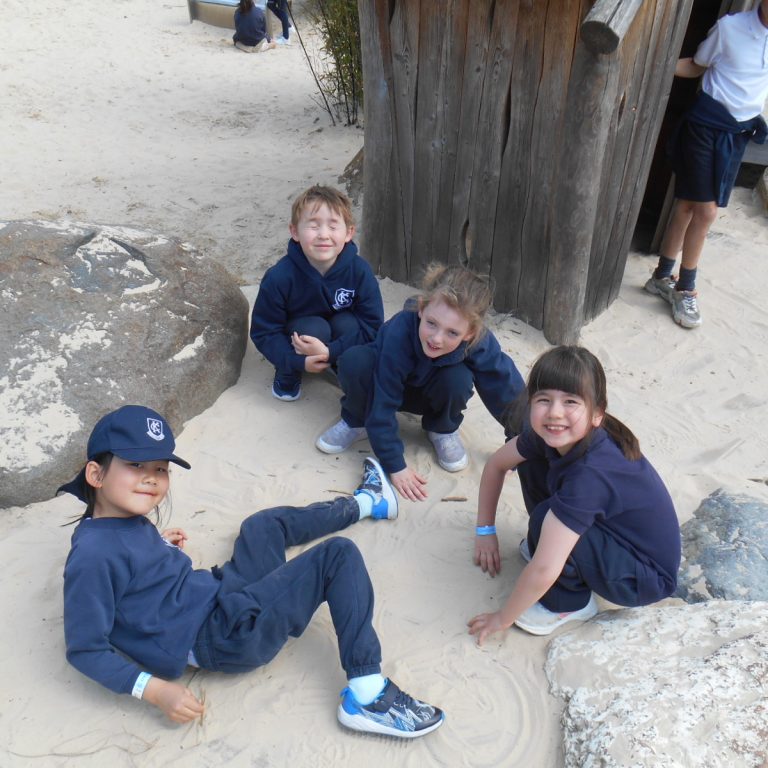 students playing in sand