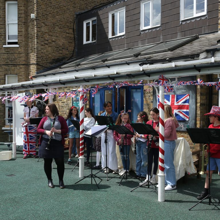 students and teachers playing musical instruments