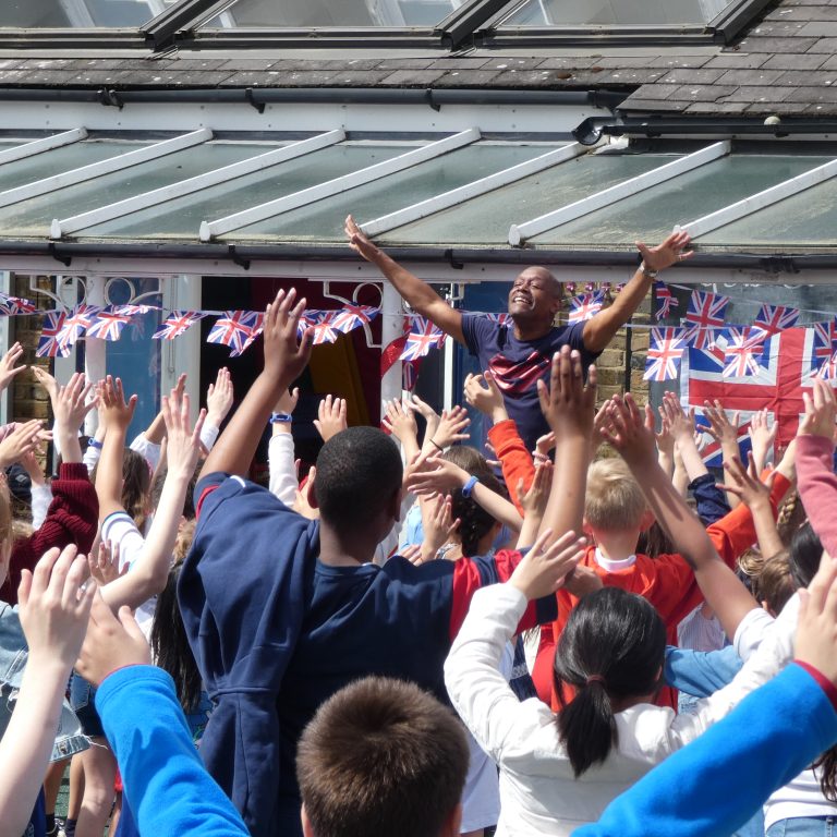 students with their arms in the air