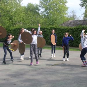 students holding sphere shields