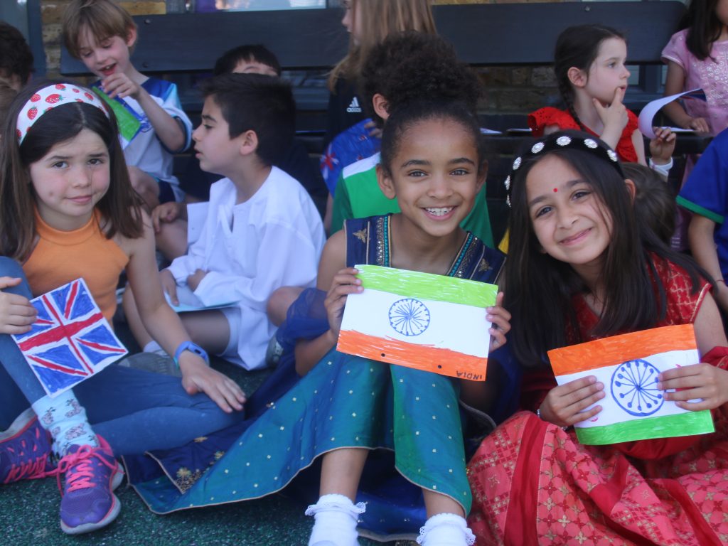 girls smiling holding their flags