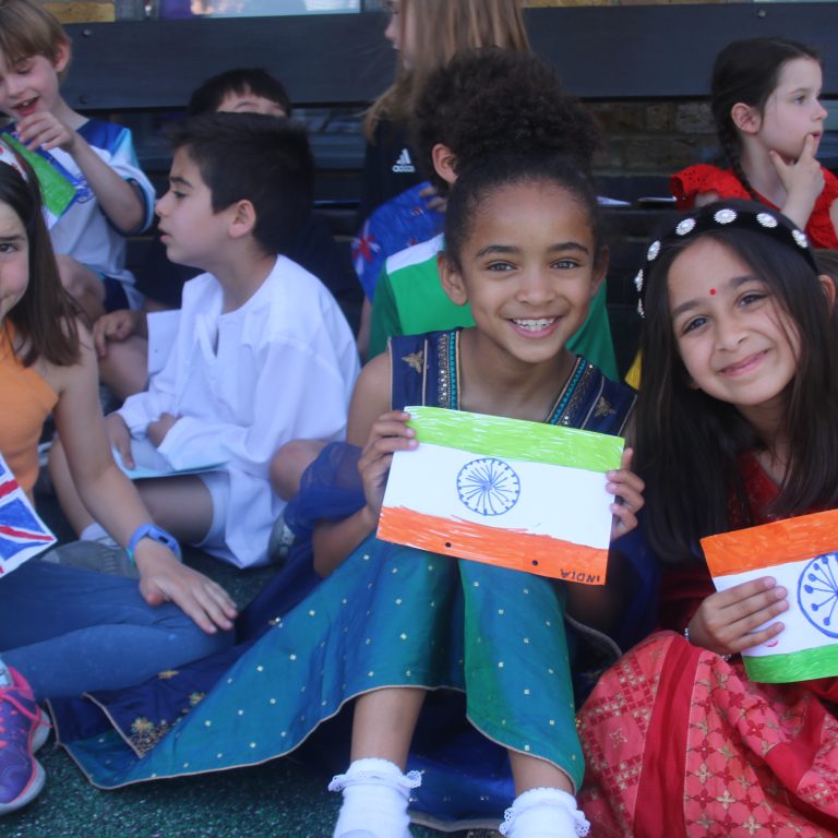girls smiling holding their flags