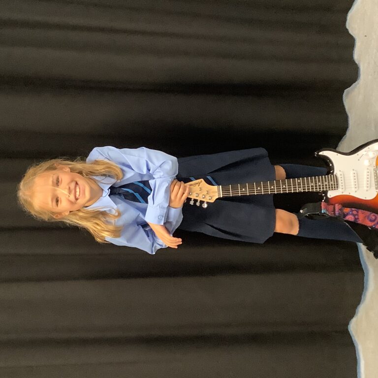 girl leaning on a guitar